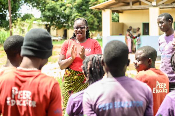 Volunteer Monica Atim talks to a group of peer educators she's trained