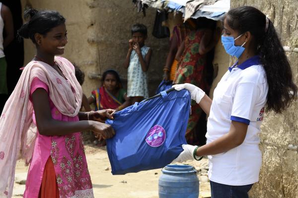 VSO volunteer giving Hygenic Kit to a girl in Nepal.