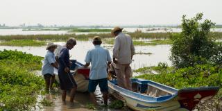 Fishermen gathered around boats by the Tonle Sap, Cambodia.