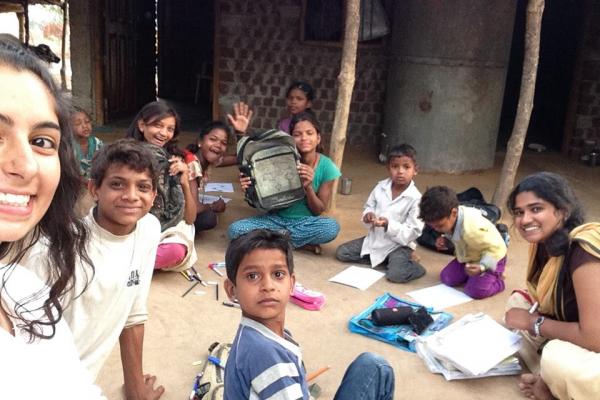 Schoolchildren hold up the schoolbags they will send to local politicians