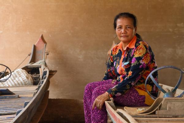 Yu Saret sits near her house in Kampong Chhnang province