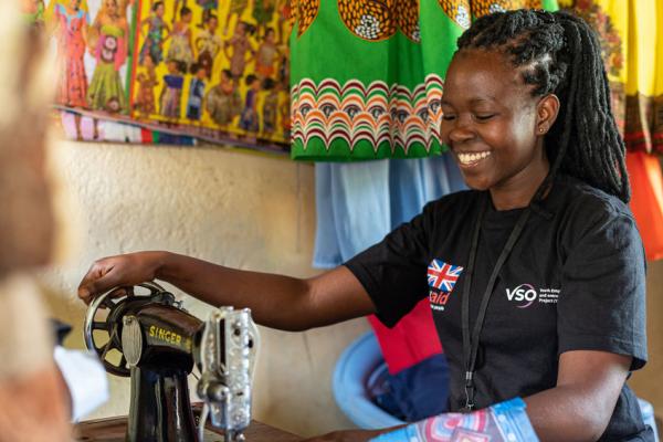 Young seamstress on the youth empowerment and employment project uses her sewing machine