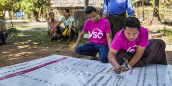 volunteer prepares to set up the disaster risk management committee (DRMC) signboard at Kyatkathone Village,Kyike Ma Yaw Township, Mon state, Myanmar