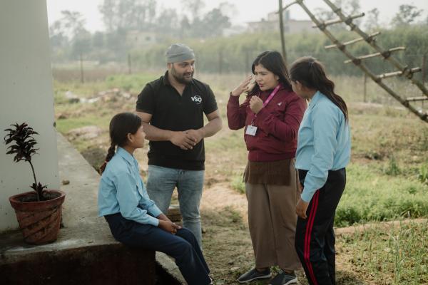 Young girls being taught sign language