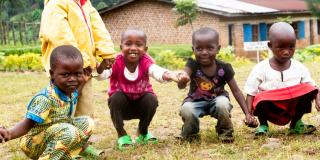 Young children play with the volunteers