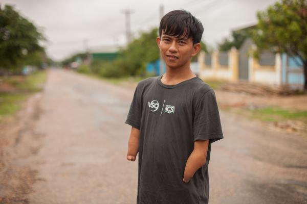 Disabled Cambodian volunteer Ouk poses in the street