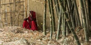 Woman sitting by a wall in Nepal