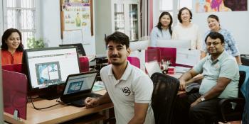 Volunteer Raj in the Kathmandu VSO office with staff members.